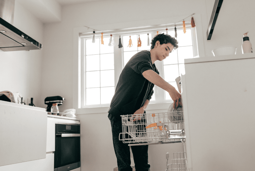 A teenager putting dishes away