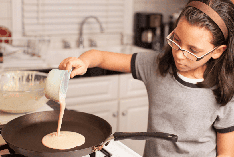 10 year old girl making breakfast making pancakes