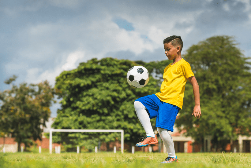 Child showing self discipline and focus in football training