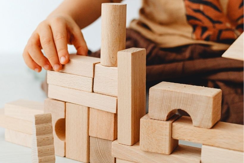 Boy playing with wooden blocks 